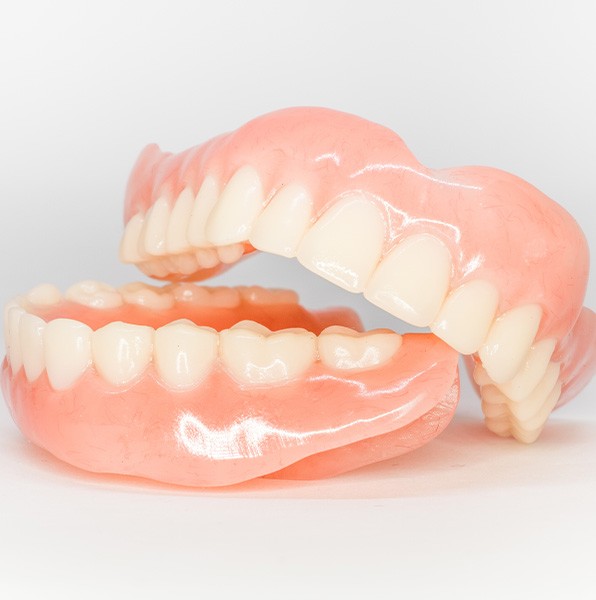 Full set of dentures on a white background