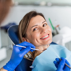 Woman smiling at dentist during checkup