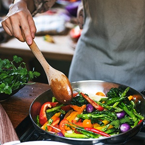 Closeup of person cooking vegetables